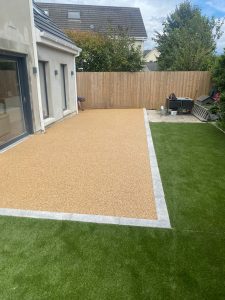 Artificial grass back garden with resin patio