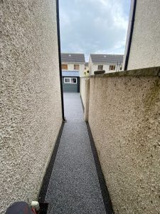 Side entrance to house with resin paving